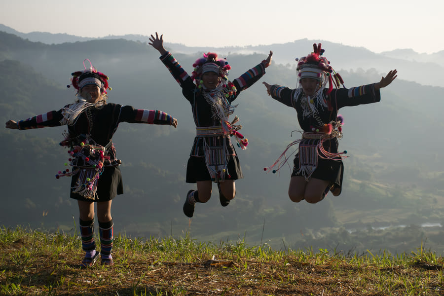 akha hombres vestidos tradicionalmente saltando china